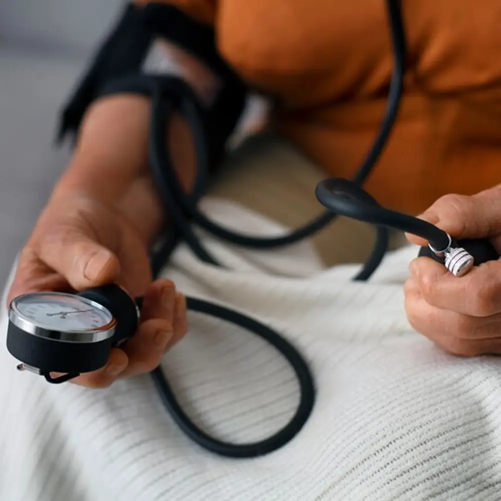Person checking blood pressure with a monitor
